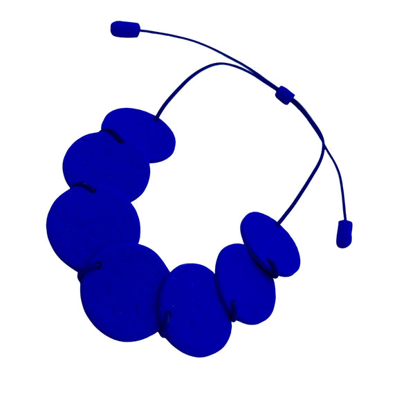 Royal blue polymer clay statement necklace with overlapping discs on an elastic cord 