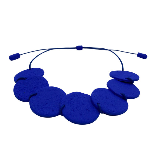 Royal blue polymer clay statement necklace with overlapping discs on an elastic cord 