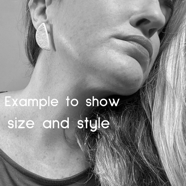 Someone wearing polymer clay half circle stud earrings. Image is in black and white to show size and style of earring.